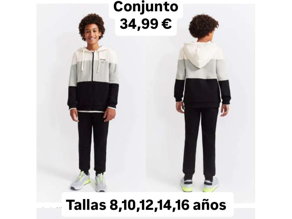 Un niño nos enseña el conjunto de dos piezas con chaqueta abierta y pantalón negro a juego