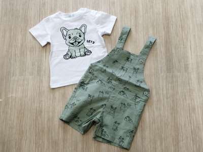 La camiseta tiene el dibujo del perro que aparece en el estampado del peto