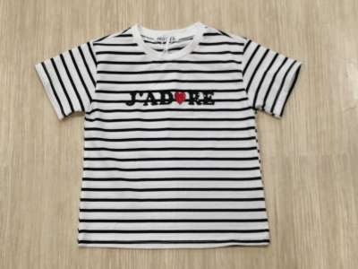 Camiseta blanca con rayas negras horizontales y letras en negro con brillo